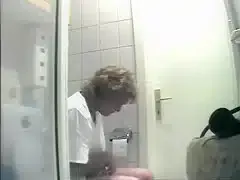 Mature is being filmed when urinating in the bathroom