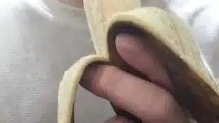 Peel and eat a large, black banana by hand.