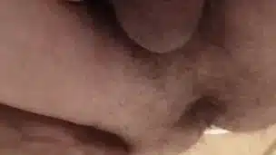 A man pissing on the toilet close-up.