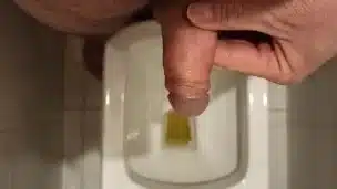 The guy jerks off after pissing.